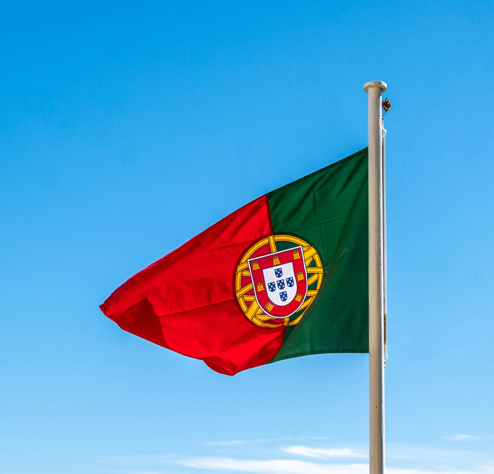 Portugal flag set against a blue sky background