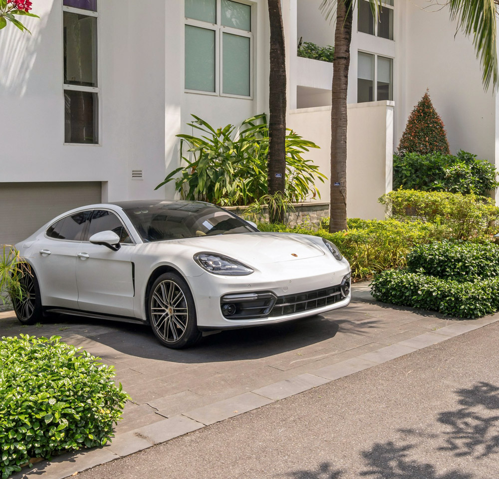 White Porsche parked outside house